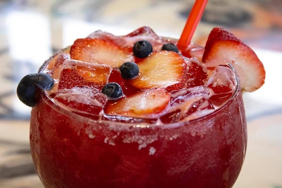 A red sangria-style margarita with fresh fruit.